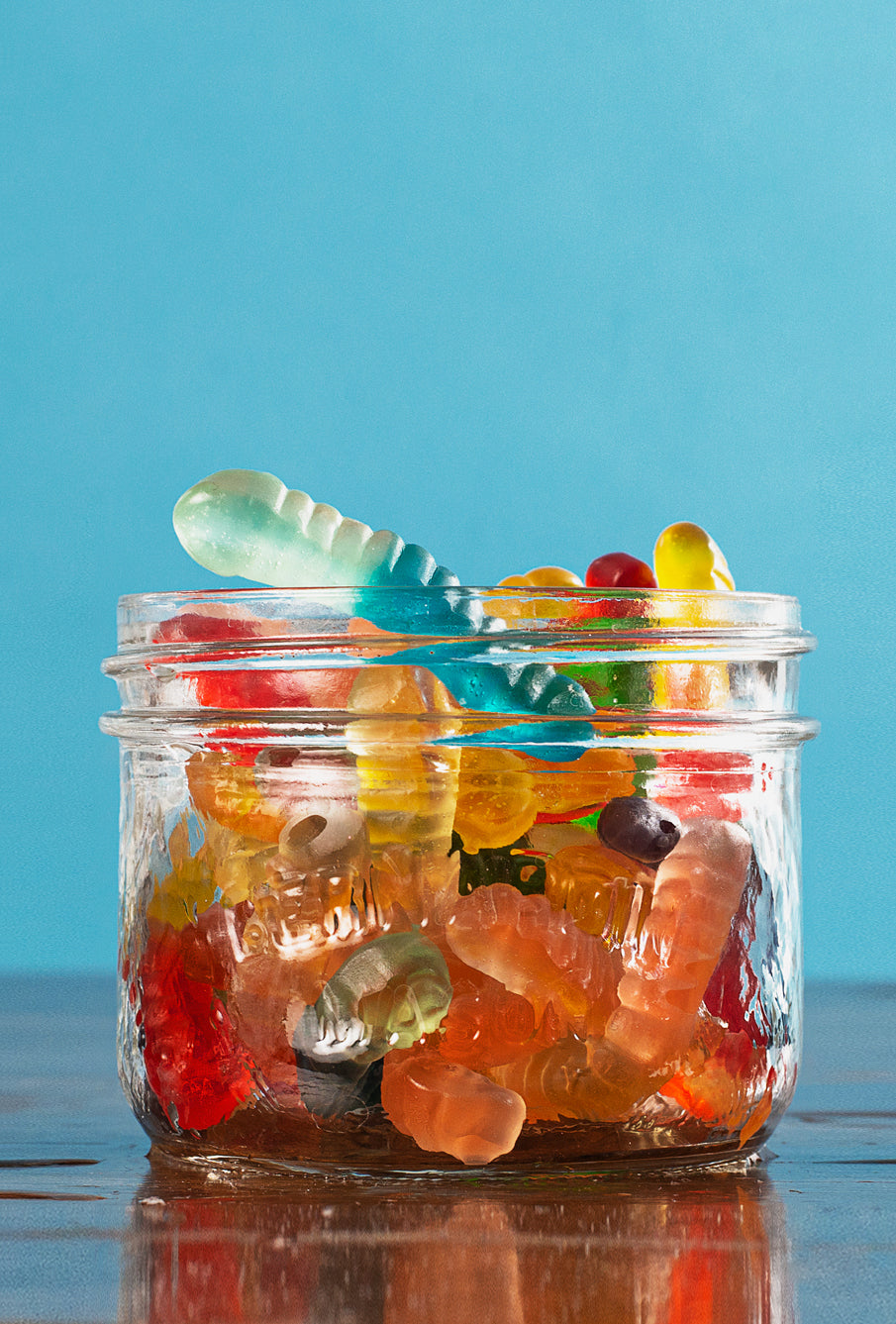 Clear glass jar filled with gummy worms
